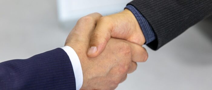 Business handshake representing alignment between R&D and commercial goals Business handshake representing alignment between R&D and commercial goals